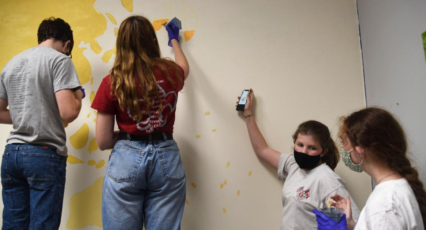 MU freshman leads the girls in mural painting
