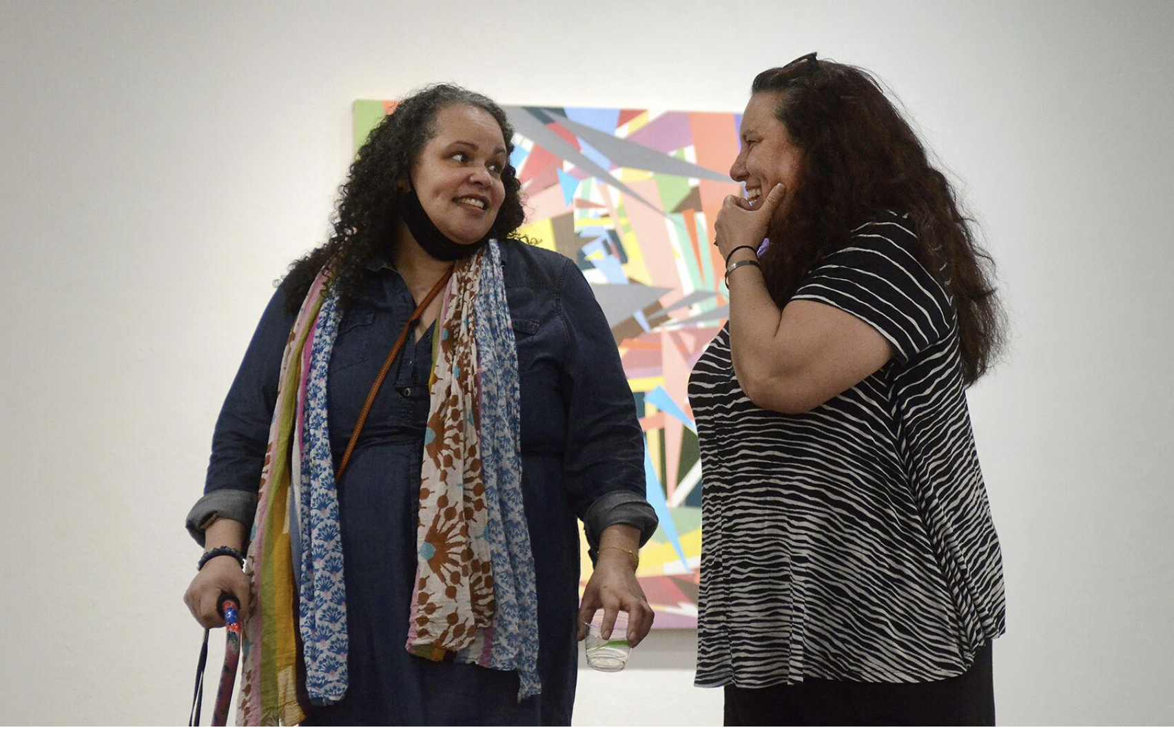 Jessica Thornton, left, and Catherine Armbrust introduce themselves and the gallery to people attending the reception