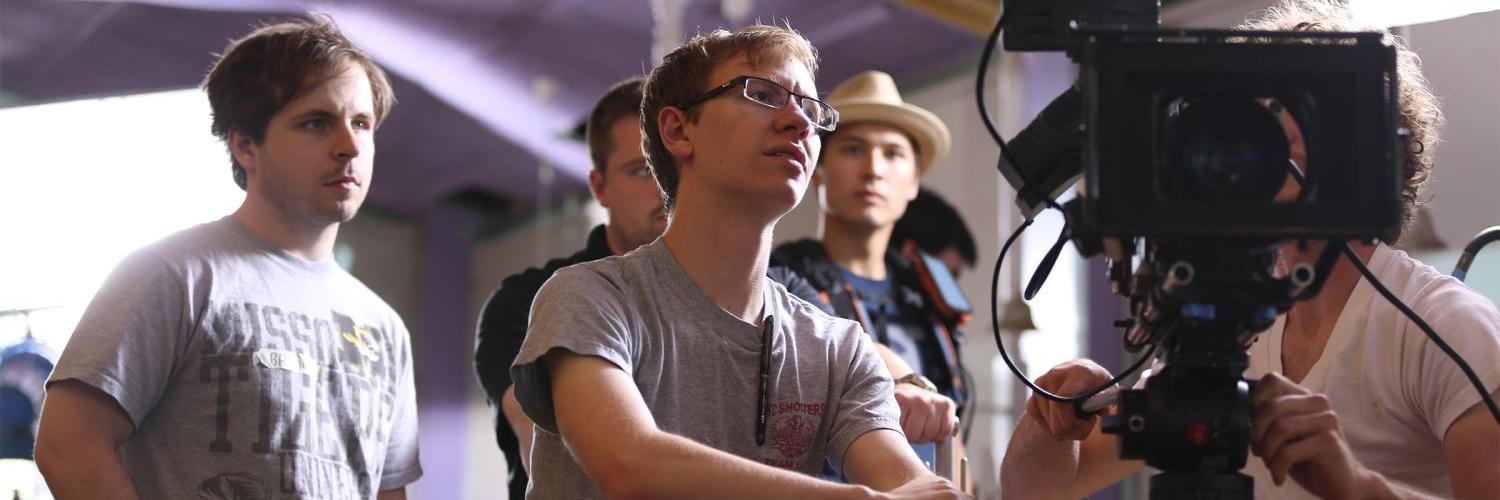 A photo of students looking into a camera