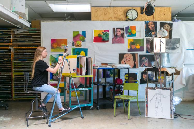 A photo of a lady painting.