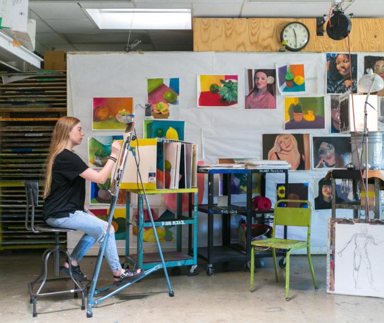 A photo of a lady painting.