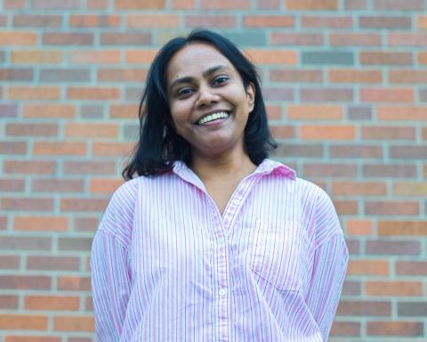 Muditha Pathirana standing in front of a multi colored brick wall