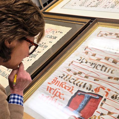 Virginia Blanton examining an ancient manuscript