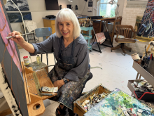 Lee Ann Garrison painting in her studio
