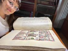 Mariana Guzman reviewing a historical document