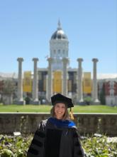 Graduate Audrey Florey standing in front of the mizzou columns