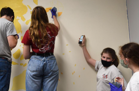 MU freshman leads the girls in mural painting