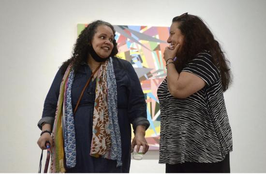 Jessica Thornton, left, and Catherine Armbrust introduce themselves and the gallery to people attending the reception