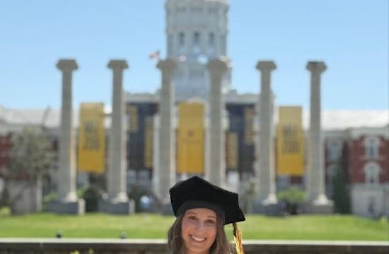 Graduate Audrey Florey standing in front of the mizzou columns